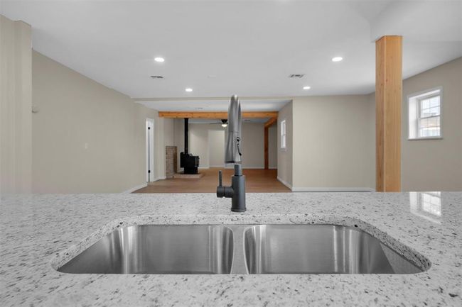 Kitchen with sink, light stone counters, and light hardwood / wood-style flooring | Image 24