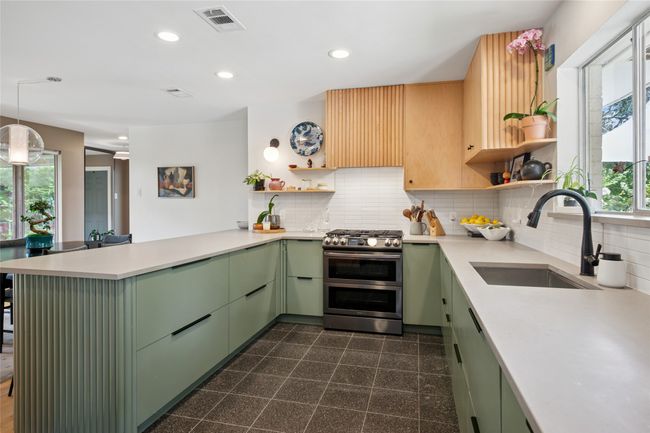 Stainless stain appliances, including a gas range and oven. | Image 10