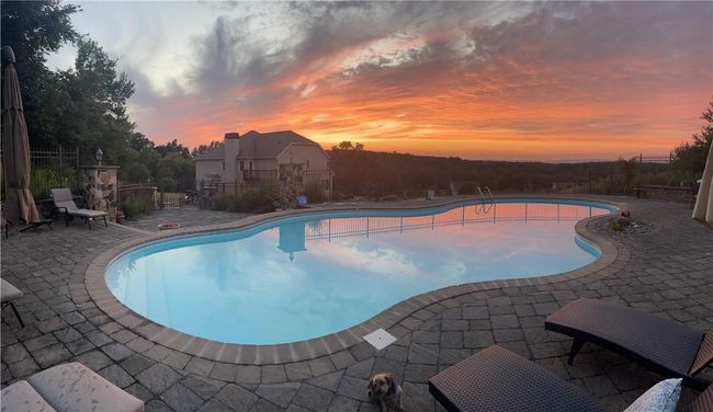 Pool at dusk featuring a patio | Image 30