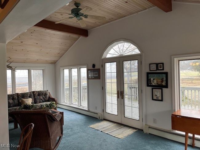 French doors to outside with lofted ceiling with beams, lots of natural light | Image 12