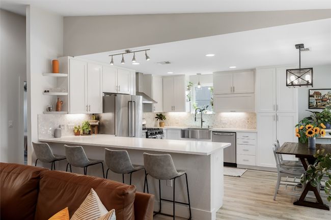 Quartz counters, tile backsplash and custom built-ins offer excellent storage. | Image 15