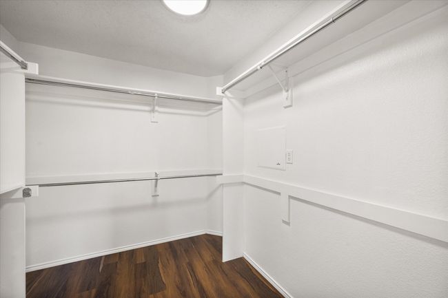 Walk in closet with dark wood-type flooring | Image 14