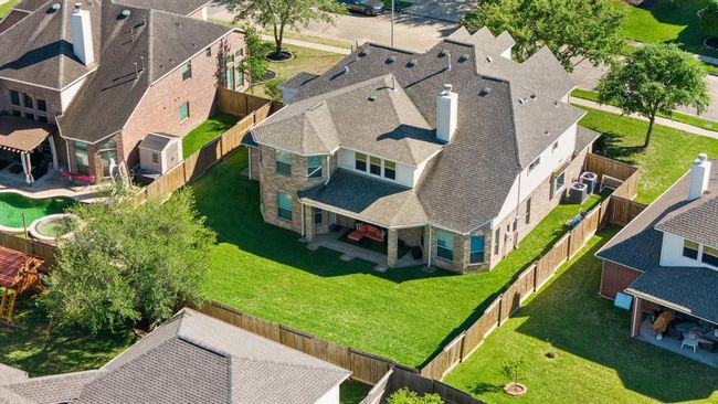 Located within a short distance of the subdivision's lake, this is an aerial view of the home & fence lines. | Image 43
