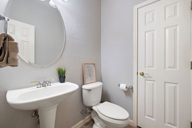 The downstairs half bath has a great storage closet! | Image 23