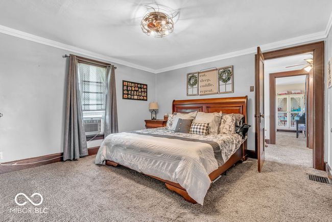 carpeted bedroom featuring ornamental molding and cooling unit | Image 31