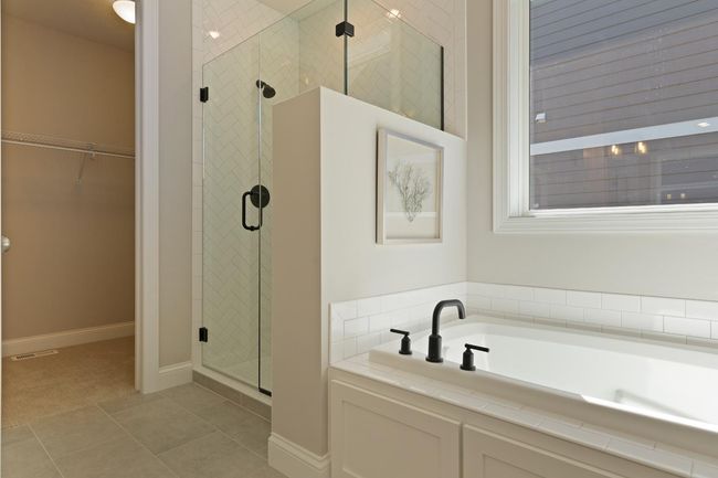 Separate tiled shower and soaking tub. And separate water Closet! And Large Closet includes shelving (not shown). Photos may not depict actual home plan configuration. Features/materials/finishes shown contain options that are not included in price. | Image 13