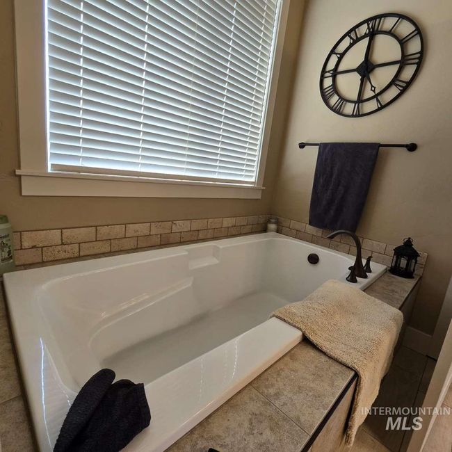 Bathroom with plenty of natural light and a bath | Image 19
