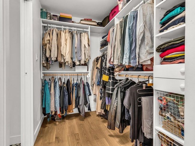 Spacious closet with wood finished floors | Image 22