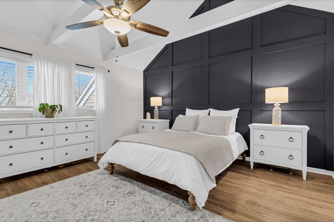 Primary Suite with a textured accent wall and beams for character | Image 20