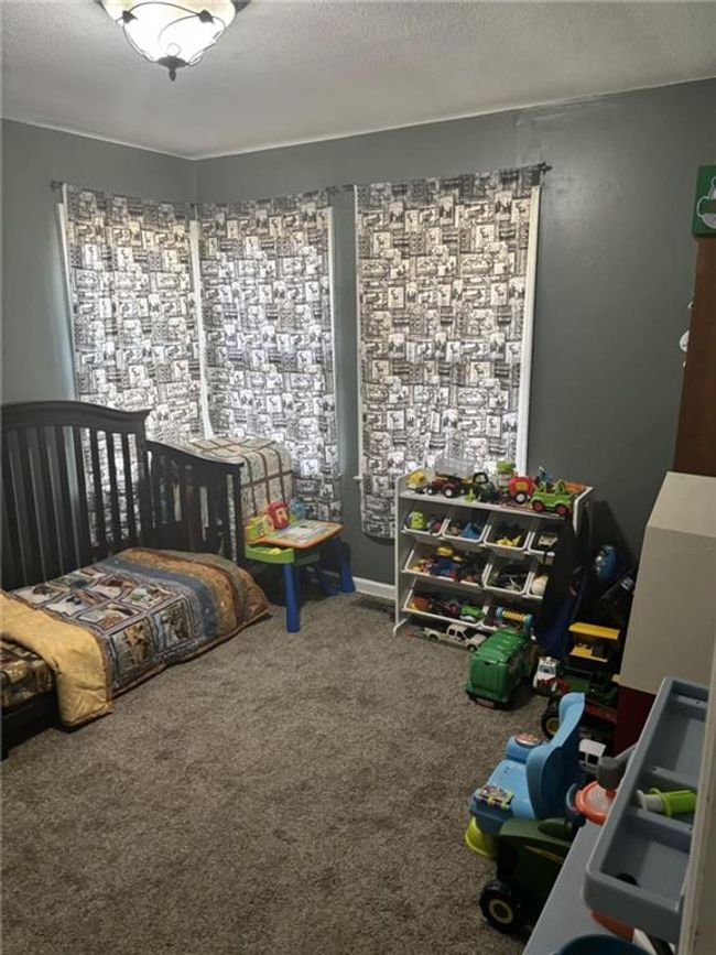 Carpeted bedroom with a textured ceiling | Image 20