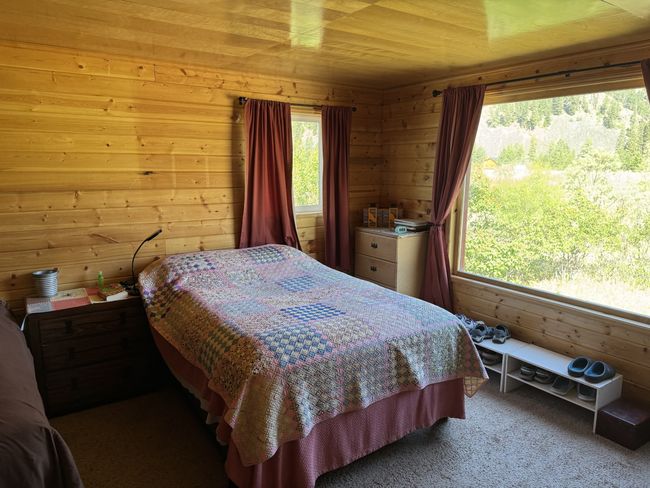 Bedroom featuring carpet and wood walls | Image 7