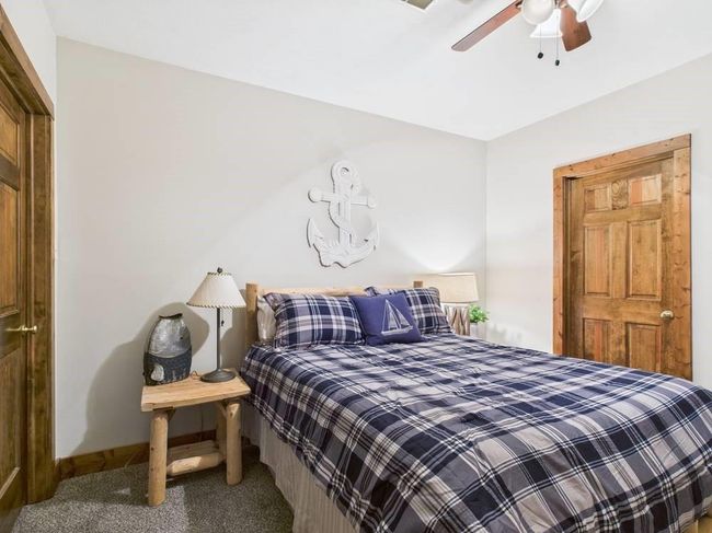 Bedroom 3 with ceiling fan, baseboards, and carpet floors showing doors to adjoining closet and utility room | Image 61