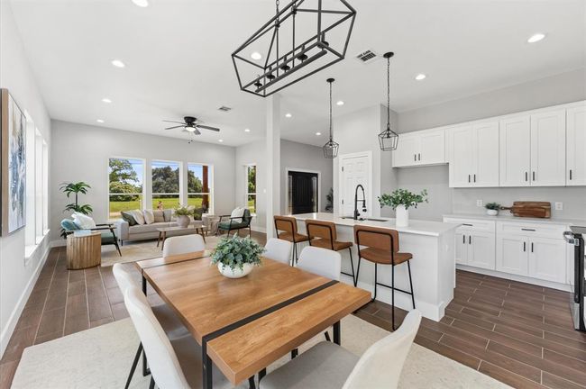 Living room seamlessly connects to kitchen and dining area. | Image 7