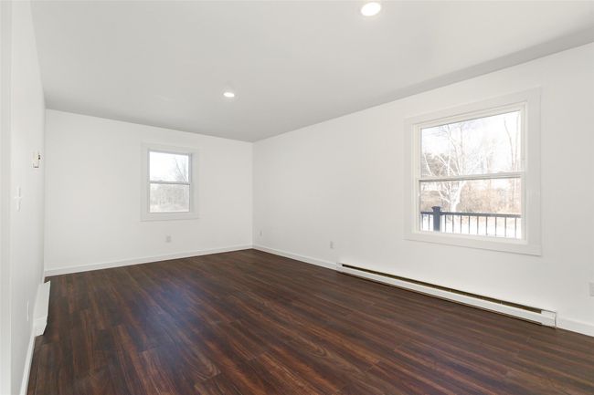 Living Space featuring plenty of natural light, a baseboard radiator, dark wood-style floors, and recessed lighting | Image 4