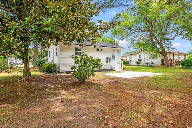 Rear view of house with a patio and a lawn | Image 17