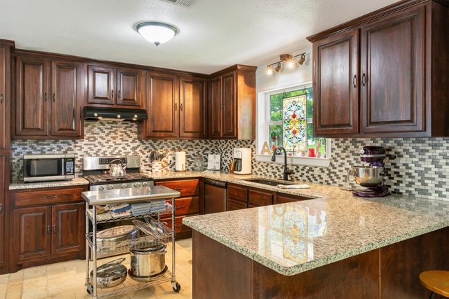 This kitchen is fabulous! Granite countertops, farm sink, gas stove and oh my.....so much storage! | Image 10