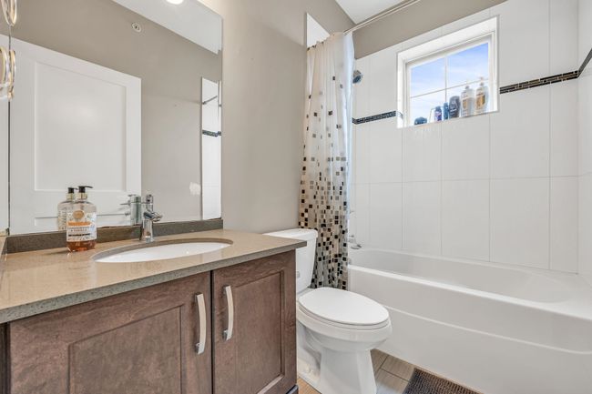 Bathroom with toilet, vanity, and shower / bath combo | Image 17