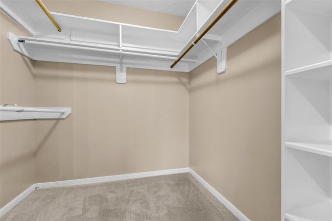 A large walk-in closet in the primary bedroom. | Image 20