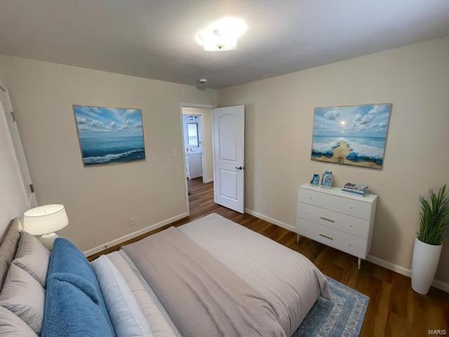 Bedroom featuring baseboards and wood finished floors | Image 12