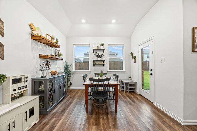 Dining space featuring lofted ceiling, dark wood-style flooring, baseboards, and recessed lighting | Image 8