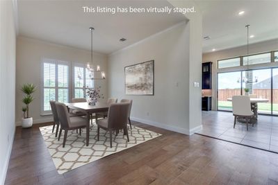 Large dining room with water views flows into kitchen and main living area. Check out that wall of glass sliders! | Image 2