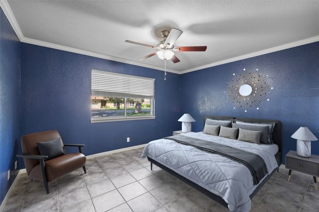 Bedroom with ornamental molding, a textured ceiling, baseboards, a ceiling fan, and tile patterned floors | Image 15