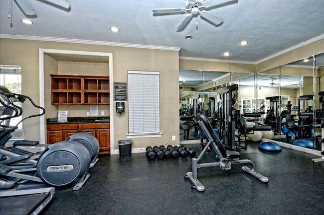 Workout area with a ceiling fan, crown molding, recessed lighting, and a textured ceiling | Image 16