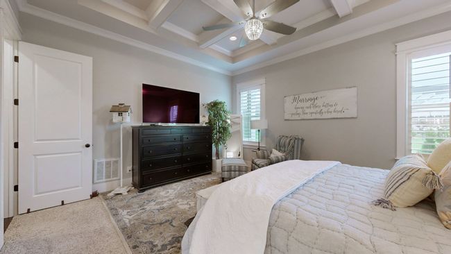 This luxurious master suite offers the perfect blend of comfort and style—featuring stunning coffered ceilings, warm natural light, and a cozy sitting area that creates a peaceful retreat you’ll never want to leave. | Image 29