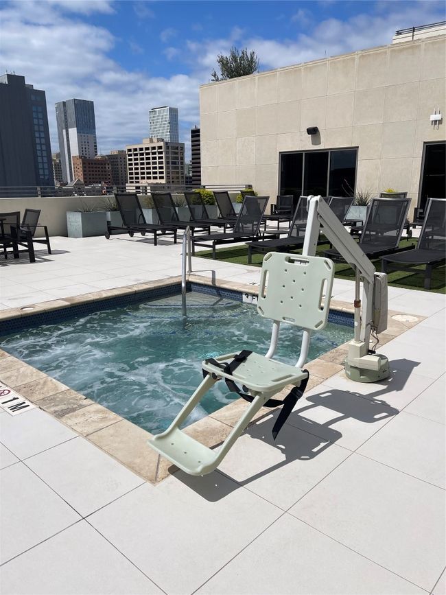 View of swimming pool with a view of city and a patio | Image 11