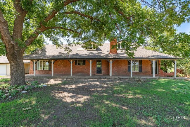 View of front of home with covered porch and a front yard | Image 31