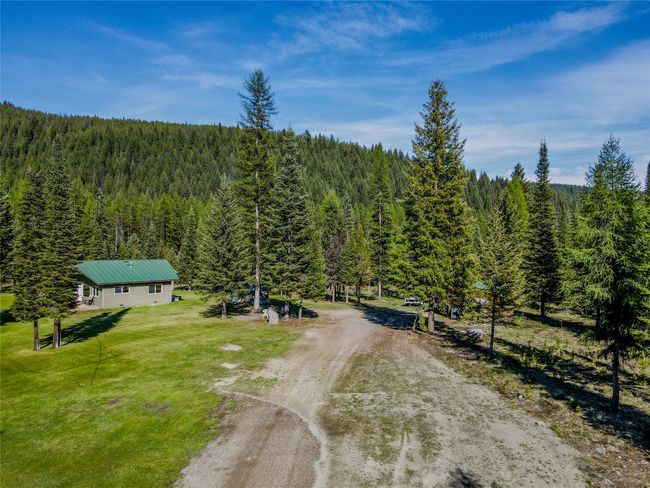 Aerial view of property and surrounding area with a heavily wooded area | Image 64