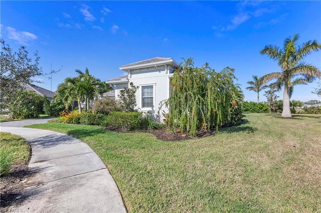 View of property exterior with stucco siding and a lawn | Image 17