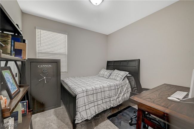 Carpeted bedroom with an office area | Image 28