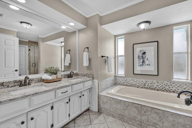 Full bathroom with tile patterned floors, a sink, crown molding, and a garden tub | Image 28