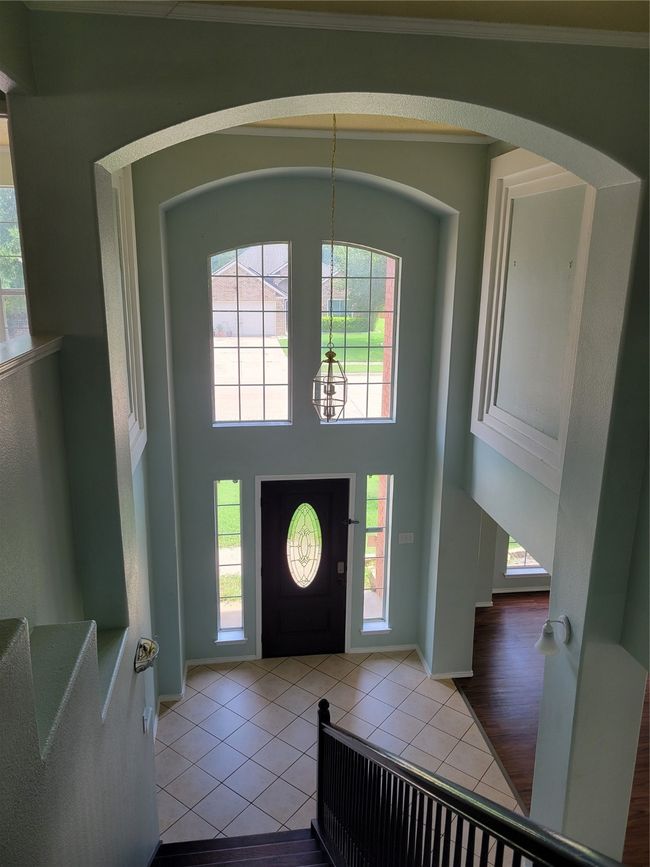 Tiled entryway with plenty of natural light, a towering ceiling, a chandelier, and arched walkways | Image 13