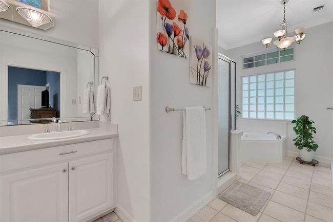 Large primary bathroom includes large soaking tub and a separate shower | Image 31