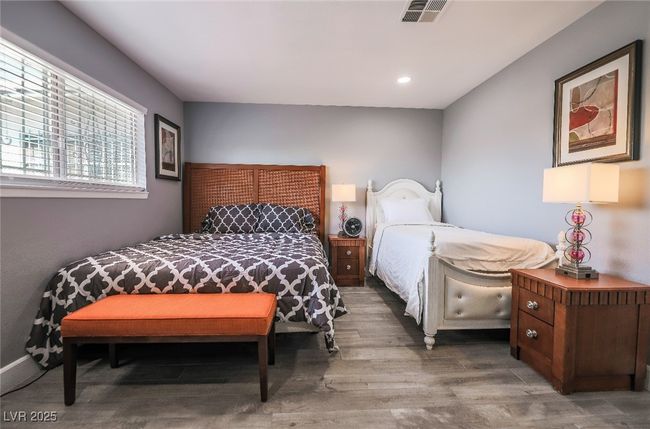 Bedroom with wood finished floors and recessed lighting | Image 31