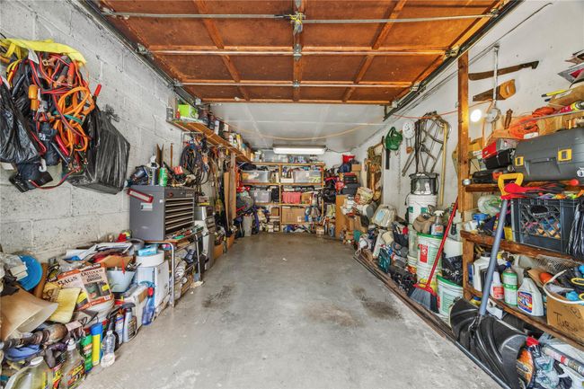 Garage with a workshop area | Image 44