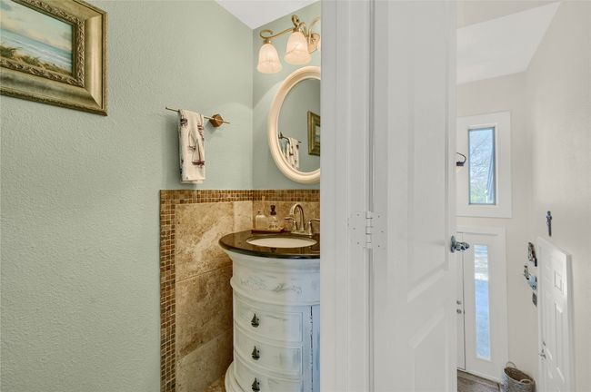Bathroom with tile walls, healthy amount of natural light, vanity, and wainscoting | Image 12