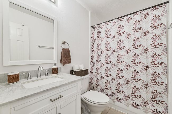 The secondary bathroom also has been updated with solid surface counters, undermounted sink and a framed mirror. | Image 19