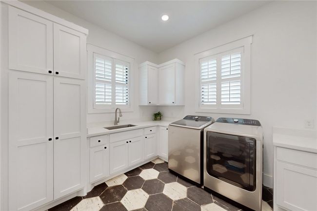 Washroom with washer and dryer, cabinet space, dark flooring, and recessed lighting | Image 15