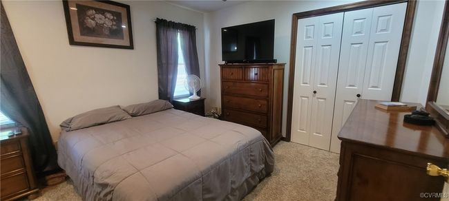 Bedroom featuring a closet and light colored carpet | Image 9