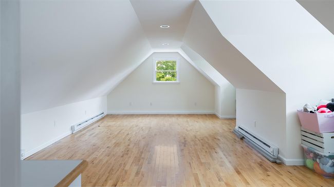 Bonus room with a baseboard radiator, light wood-type flooring, and lofted ceiling | Image 20