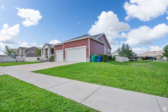 Ranch-style home featuring an attached garage, concrete driveway, and a mountain view | Image 45