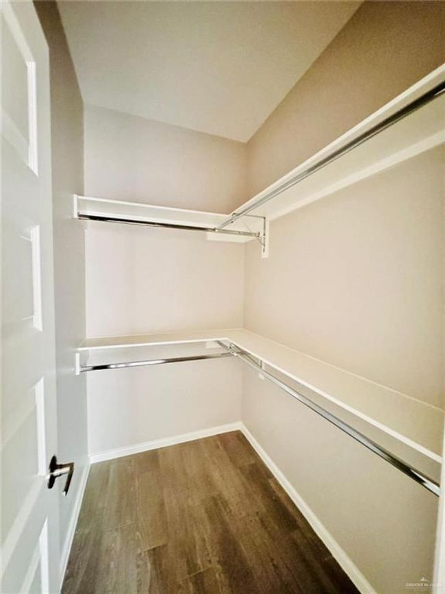 Spacious closet with wood finished floors | Image 6