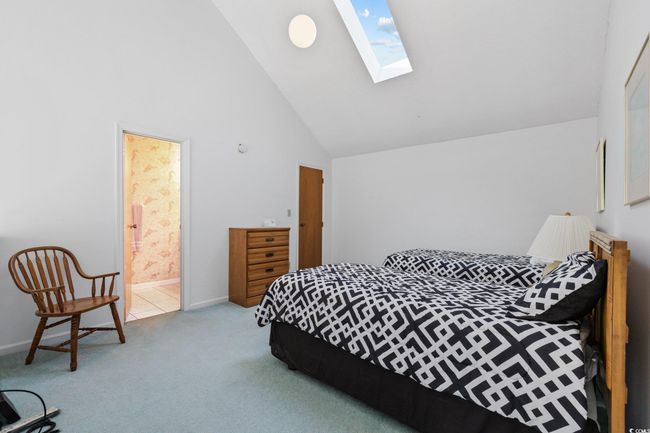 Bedroom with a skylight, high vaulted ceiling, carpet, ensuite bath, and baseboards | Image 14