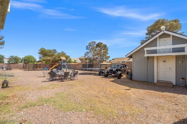 View of yard with a trampoline, an outbuilding, fence, and a playground | Image 27
