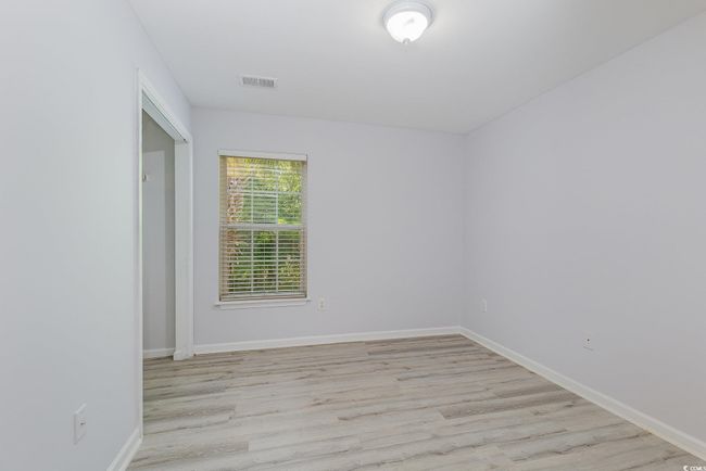 Empty room featuring light wood-style floors, visible vents, and baseboards | Image 21