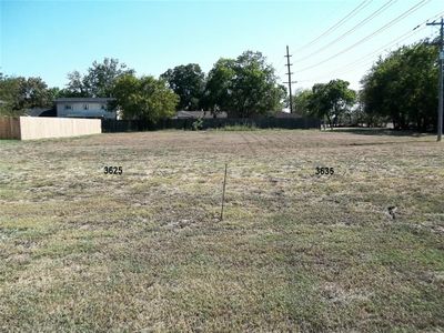 View of both lots from road. Stake shows split between lots. | Image 1