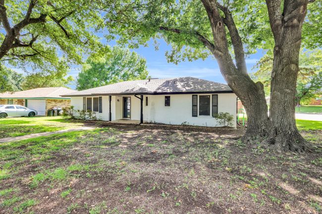 Ranch-style house featuring brick siding and roof with shingles | Image 4